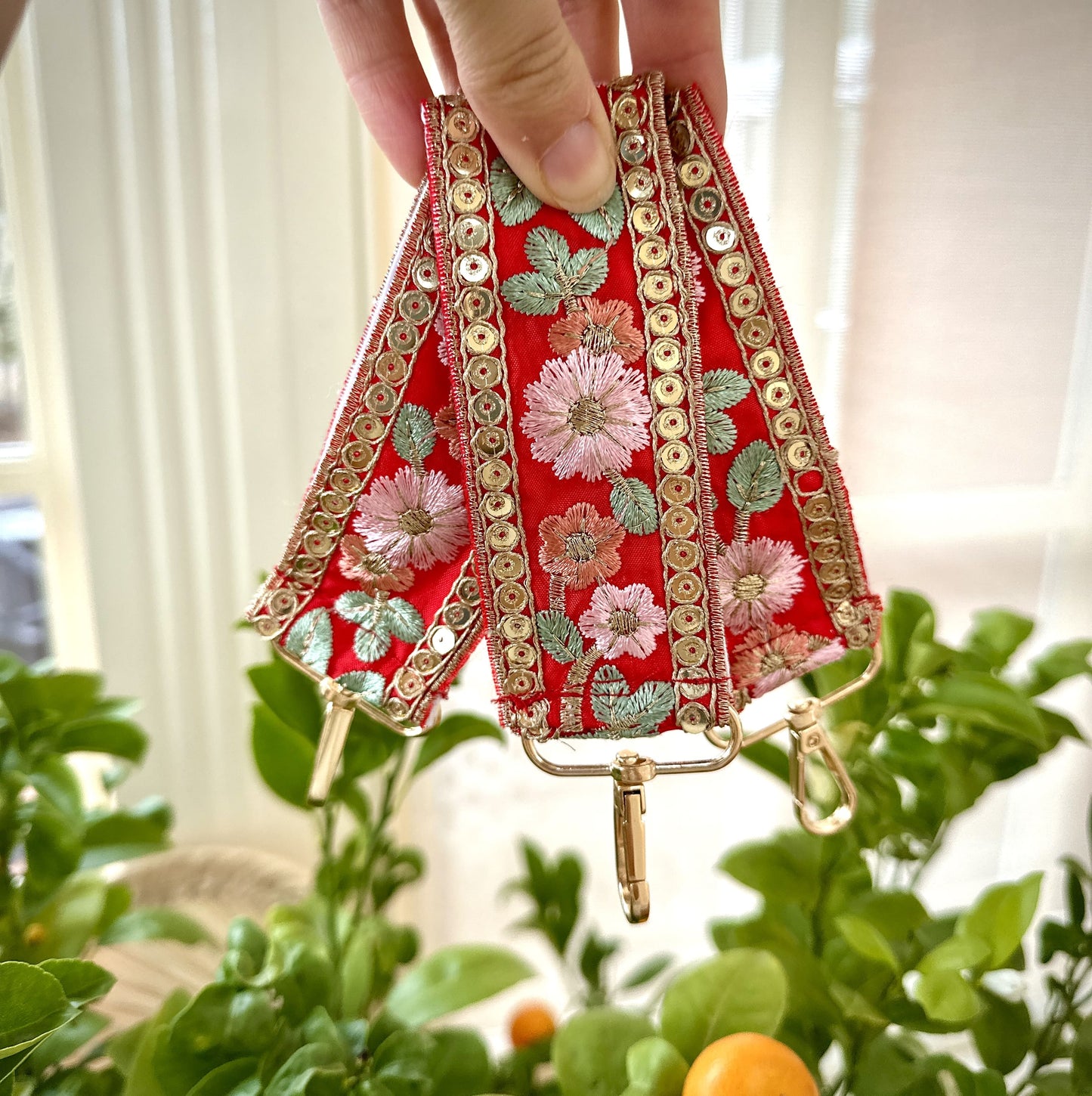 Red embroidered floral key chain ith sequin detail